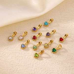 Macro detail of 12 heart-shaped colorful zircon pendants with 18K gold plated settings