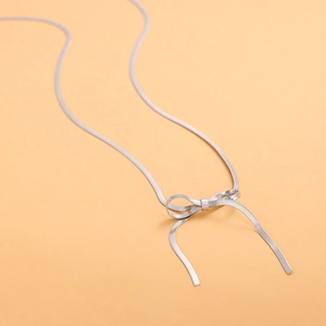 Collana a serpente in acciaio inossidabile con fiocco su sfondo arancione
