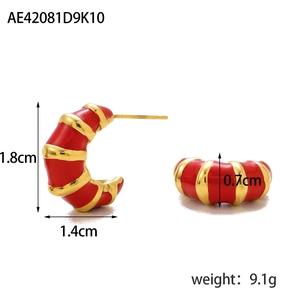 Detail view of gold-plated striped C-shaped earrings with red enamel and size measurements