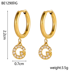 Detail view of 18K gold plated hoop earrings with zircon pavé G letter pendant