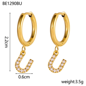 Detailed macro view of 18K gold plated hoop earrings with U-shaped zircon letter charms