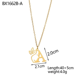 Macro detail of letter A pendant with female silhouette in 18K gold plated steel