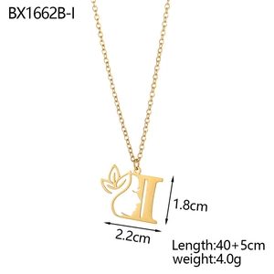 Macro detail of 18K gold-plated letter I pendant featuring leaf and female face design