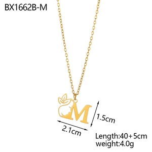 Detail view of gold letter M pendant with floral face design and dimension specs
