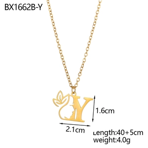 Detailed view of gold necklace with letter Y pendant featuring floral face silhouette