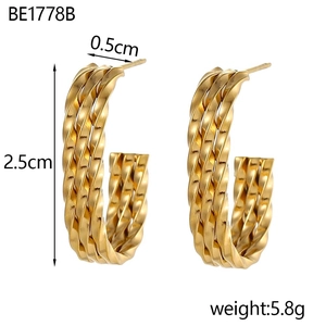Macro detail of gold-plated twisted wheat-pattern C-hoop earrings with 2.5cm height