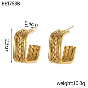 Detailed view of gold C-shaped earrings with wheat ear texture, size 2.3cm by 0.9cm