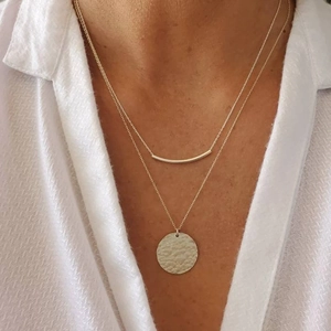 Minimalist double-layered silver necklace with curved bar and hammered disc pendant