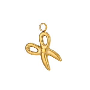 Detailed view of a golden vintage scissor pendant with 18K gold plating and ring loop