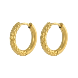 Close-up of gold hoop earrings with textured honeycomb pattern and polished mirror finish