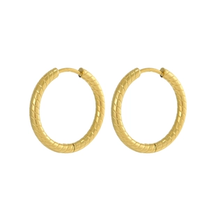 Close-up of golden stainless steel hoop earrings with detailed spiral twisted texture