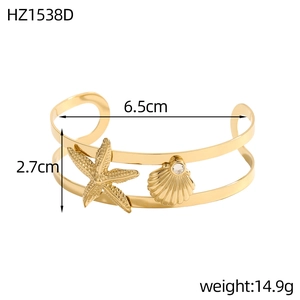 Detail view of gold seashell and starfish cuff bracelet with dimensions and weight info