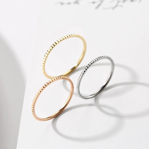 Three-piece set of textured minimalist rings in gold, silver, and rose gold finishes
