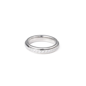 Macro view of polished spinner ring with sparkling zircon stones in a silver finish