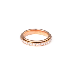 Detailed macro view of rotatable rose gold spinner ring set with sparkling white zircons