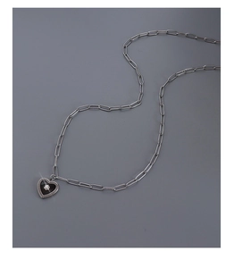 Detailed view of the black heart pendant on a stylish titanium steel paperclip chain