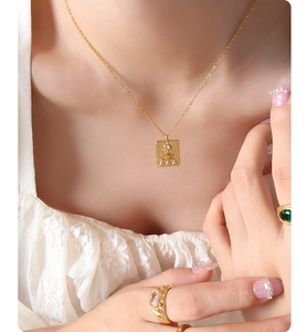 Detail of a vintage sun rectangular pendant necklace with sparkling micro-inlaid stones