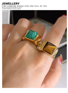 Detail von vergoldeten Edelstahlringen mit Tigerauge- und Malachitsteinen im Vintage-Stil