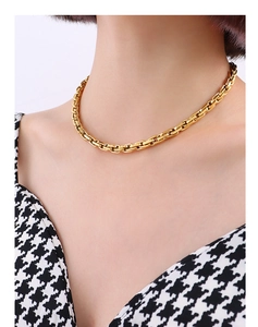 Close-up of golden chunky titanium steel chain necklace with industrial square links