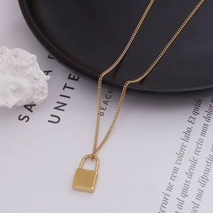 Minimalist 18k gold plated stainless steel padlock necklace on a modern aesthetic background