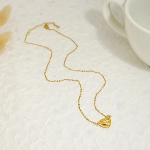 Macro shot of 18K gold plated magnetic heart pendant necklace with lobster clasp detail