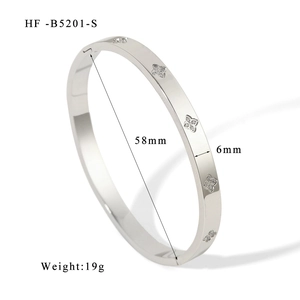 Detail view of silver lucky flower clover bangle with 58mm inner diameter and 6mm width