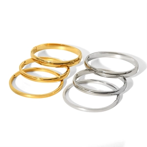 Set of minimalist 18K gold and silver plated stainless steel bangles with polished finish