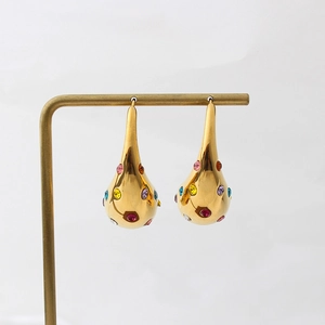 Detail of 18K gold teardrop earrings featuring colorful cubic zirconia and micro-pave setting