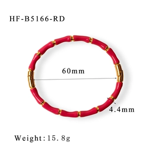 Detail of red enamel bamboo style bangle with 18K gold plated clasp and metal rings
