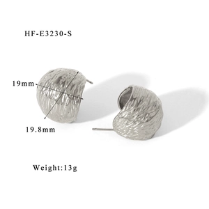 Detailed view of silver stainless steel C-shaped earrings with textured surface and size markings