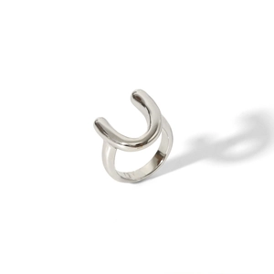Macro shot of minimalist silver stainless steel ring with a modern U-shaped geometric design