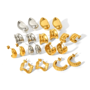 Detailed flat lay of diverse 18K gold and silver geometric irregular hoop earrings set