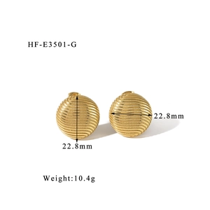 Macro detail of 22.8mm gold spherical earrings featuring wavy texture and 10.4g weight