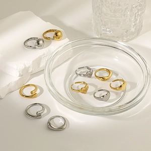 Minimalist gold and silver stainless steel heart rings set in vintage design on stone stand