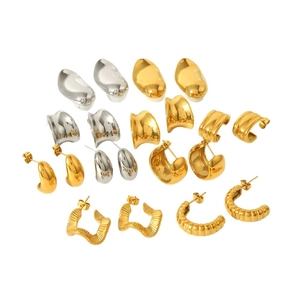 Polished 18K gold and silver geometric twisted hoop earrings set on white background