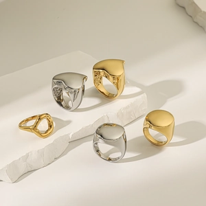 Macro view of minimalist 18K gold and silver rings with high-polish mirror finish