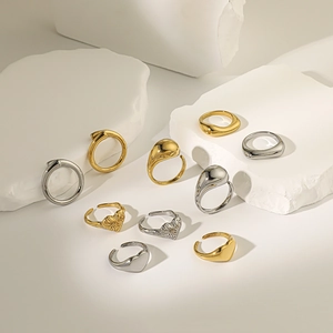 Detailed view of polished gold and silver rings on a white stone background display