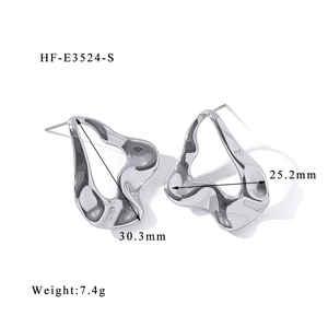 Detailed view of silver irregular fluid metal earrings with specific size measurements