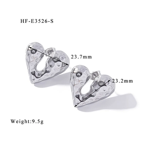 Detailed view of silver heart earrings with hammered texture and 23mm size dimensions