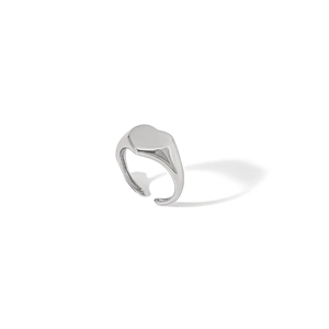 Detailed close-up of a silver heart-shaped signet ring with an adjustable open band design