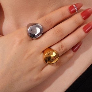 Minimalist 18K gold and silver polished signet rings set worn by a female model
