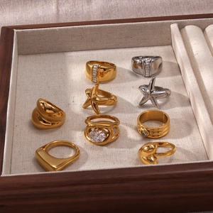 Detailed top view of nine gold 18K plated rings with starfish and heart motifs in jewelry box