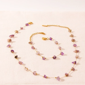 Détails macro d'un ensemble collier et bracelet en améthyste de style bohème doré