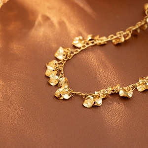 PVD gold stainless steel necklace with multiple curved petal-shaped charms on a thin chain