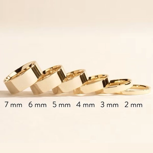 Minimalist gold titanium steel rings displayed in various widths from 2mm to 7mm