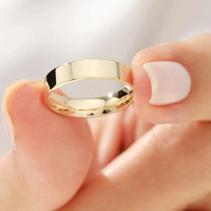 Minimalist high-polished flat titanium steel ring with a sleek gold-plated finish