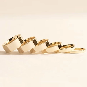 Set of six polished gold stainless steel rings in varying widths and minimalist style