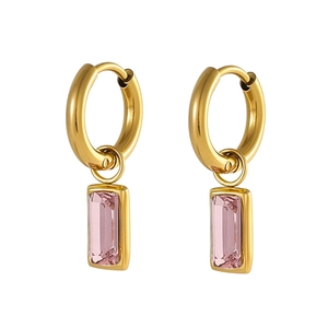 Detail von goldenen Creolen mit quadratischen rosa Kristallanhängern auf weißem Grund