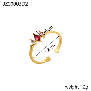 Detailed macro view of gold-plated ring with red and white marquise-cut zircon stones