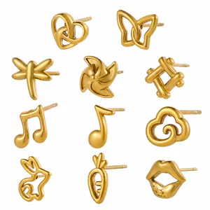 Close-up of golden dragonfly heart and musical note stud earrings in polished 18K gold finish